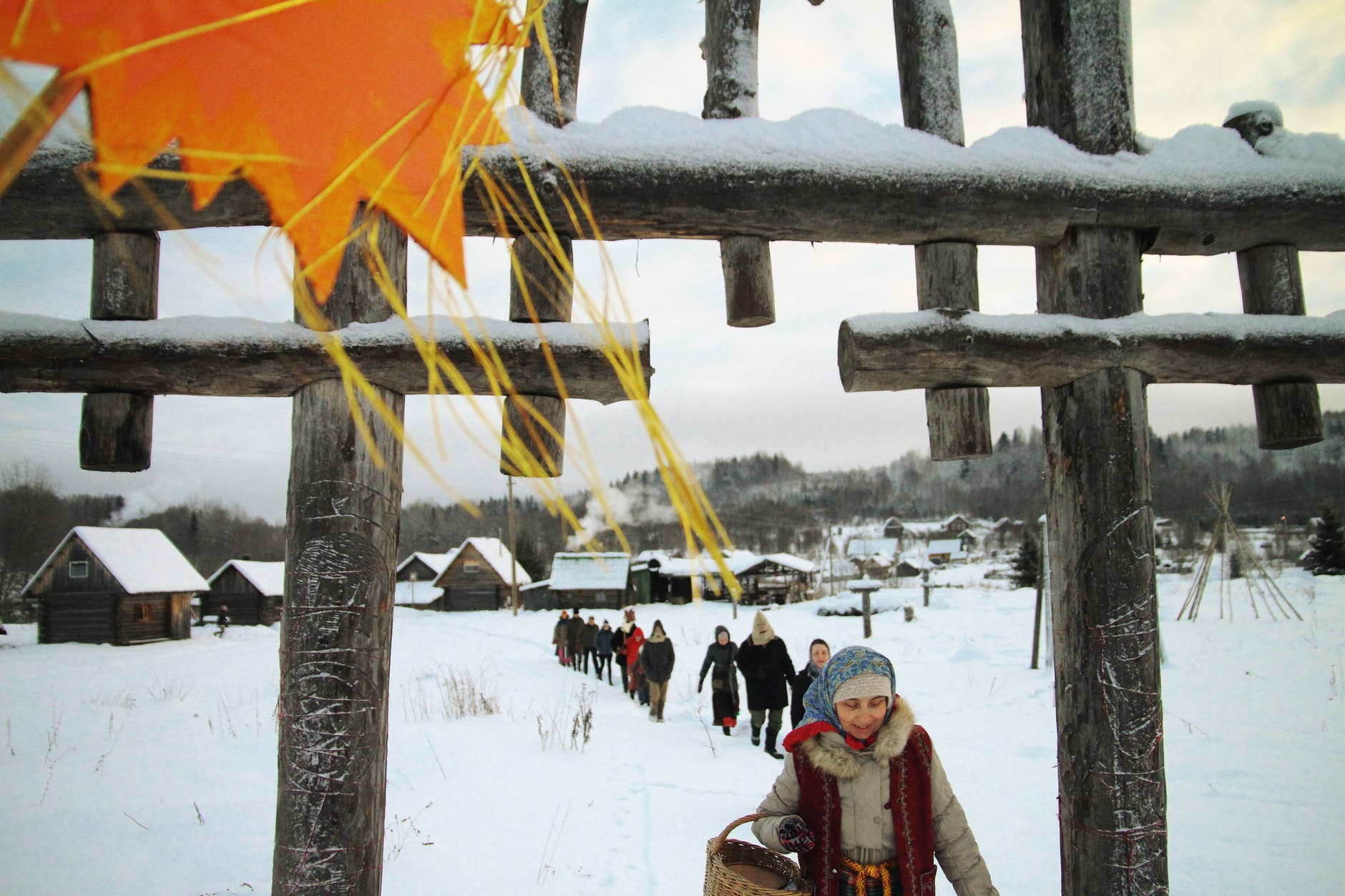 people from village walking in field in winter time