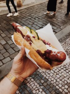 person holding hotdog sandwich