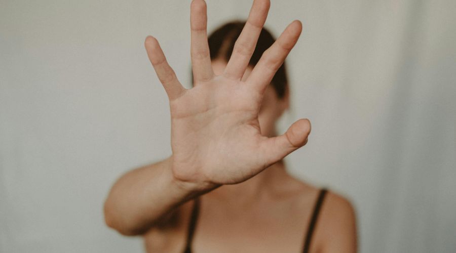 woman with hand blocking camera